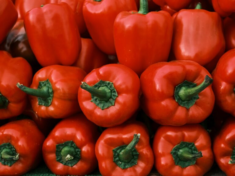 a pile of red peppers sitting on top of each other